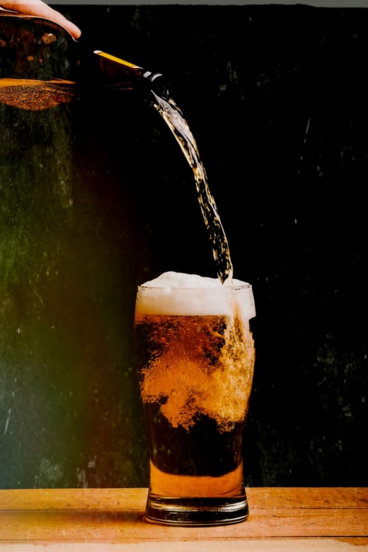 Bier wird in ein Glas geschüttet