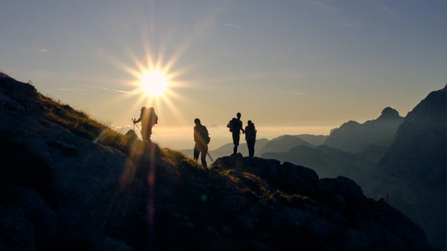 Silhouette people hiking